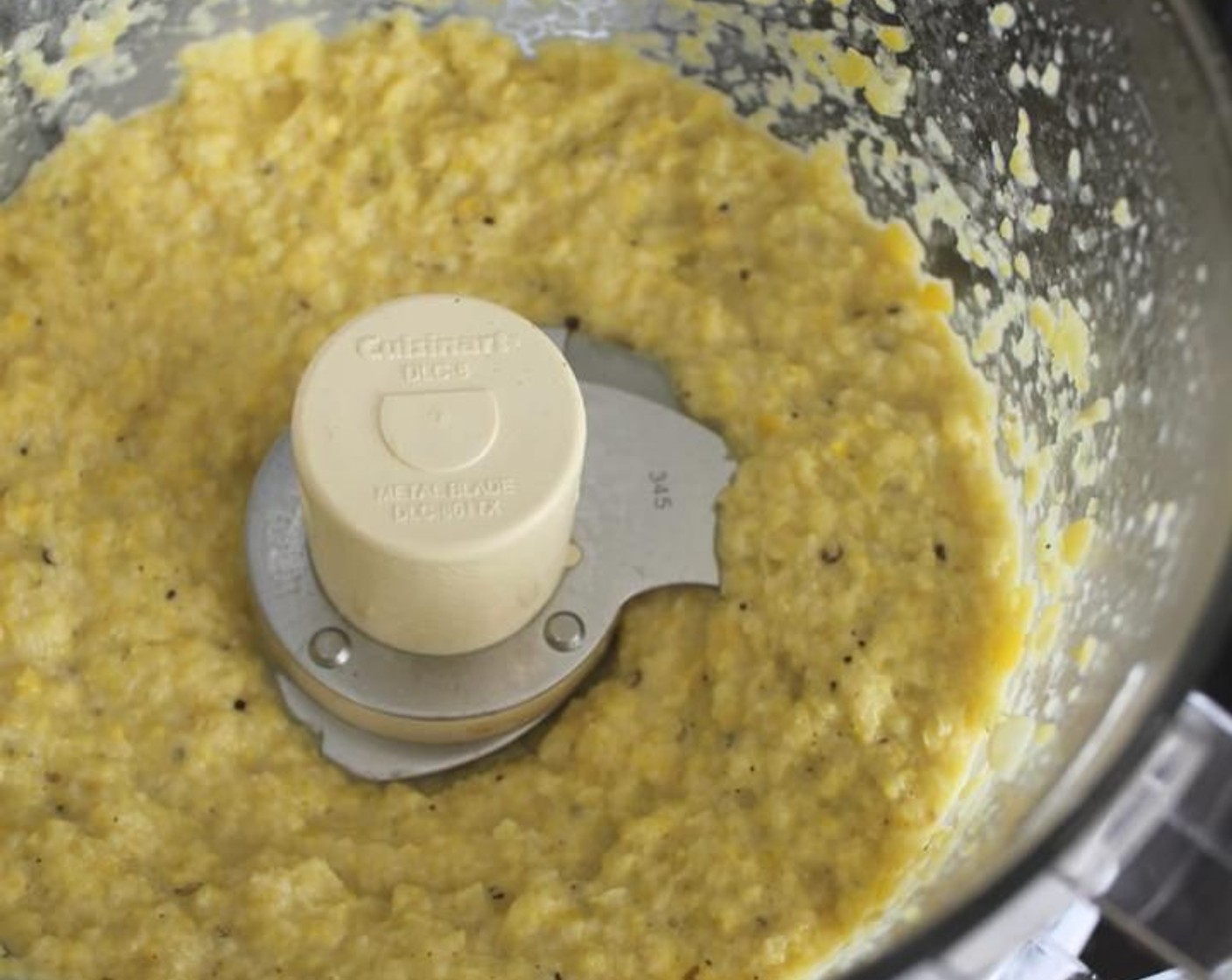 step 6 Add Kosher Salt (1 1/2 Tbsp) and Ground Black Pepper (1 tsp) to the corn and garlic and process until coarsely pureed. With the food processor running, add Extra-Virgin Olive Oil (1 Tbsp) and process until smooth.