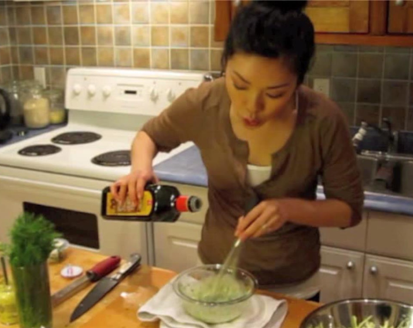 step 8 To create an emulsification, place a towel underneath the bowl. While whisking, pour Extra-Virgin Olive Oil (1/4 cup) in a steady stream until it becomes a creamy dressing.