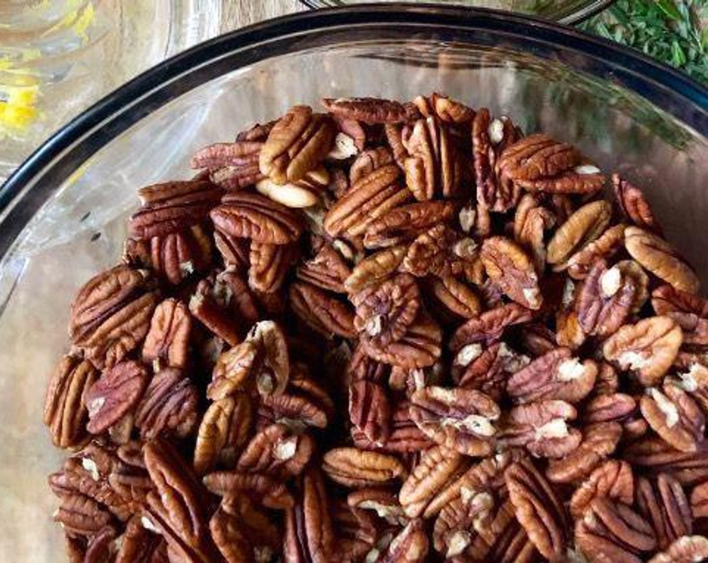 step 2 Brush a sheet pan generously with Vegetable Oil. Place the Pecan Halves (8 cups) in a large bowl.
