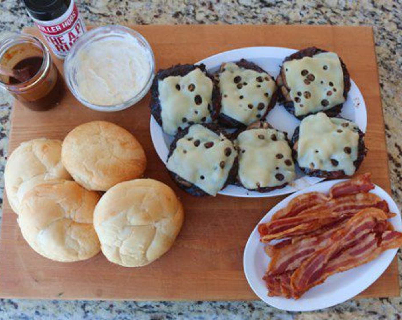 step 13 To assemble burger, split a Hamburger Buns (6) and smear Roasted Garlic Mayo on top and bottom.