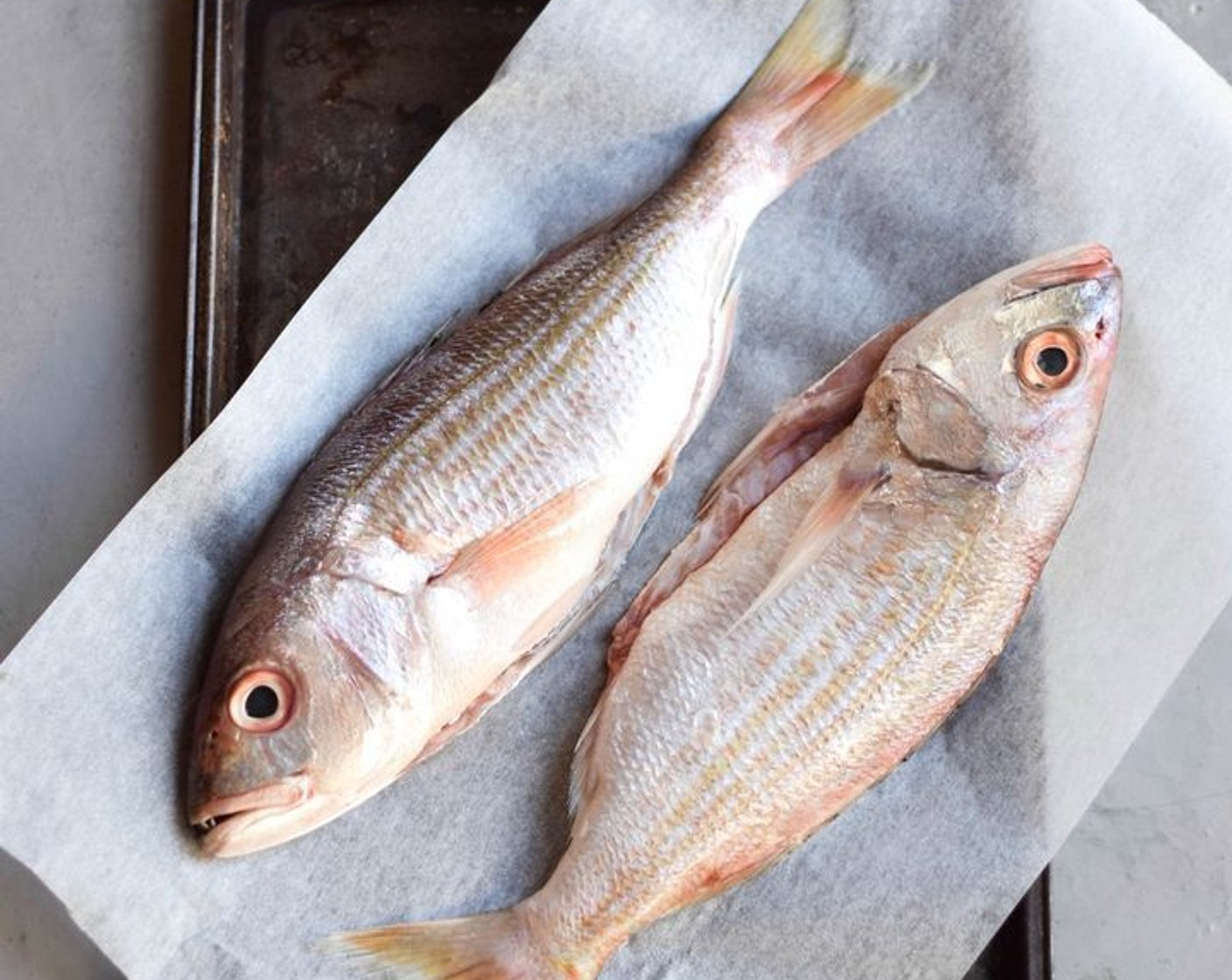 step 3 Season the fish with Coarse Sea Salt (to taste) and Ground Black Pepper (to taste), being sure to get into the stomach cavity and the slits. Arrange the fish, slit-side up on a lined baking sheet or roasting dish.