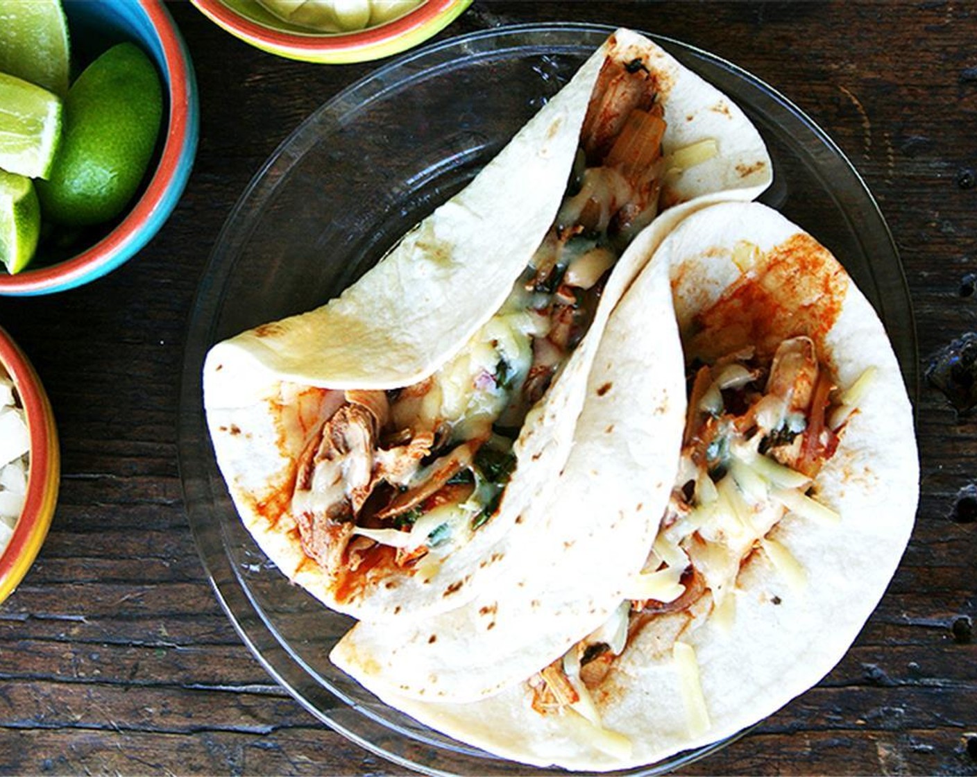 step 9 Serve with heated Flour Tortillas (to taste), Cheese (to taste), wedges of Limes (to taste), chopped onion, and Sour Cream (to taste) on the side.