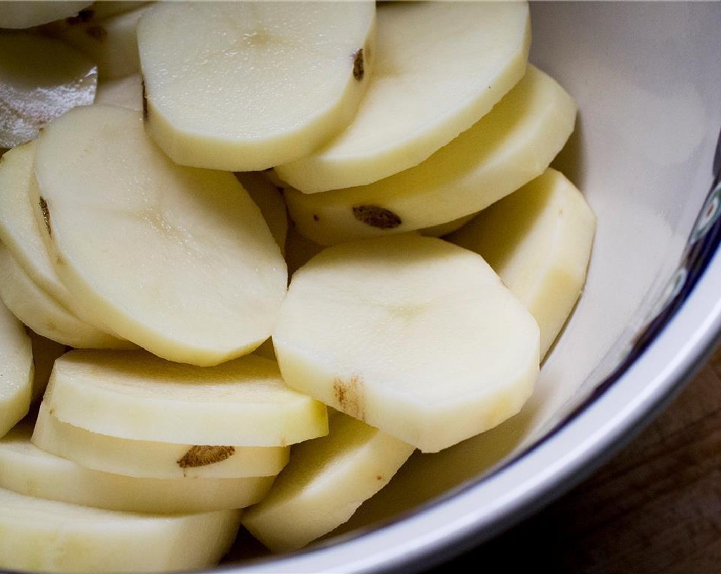 step 1 Peel and cut the Potatoes (2) into 1/4 inch slices.