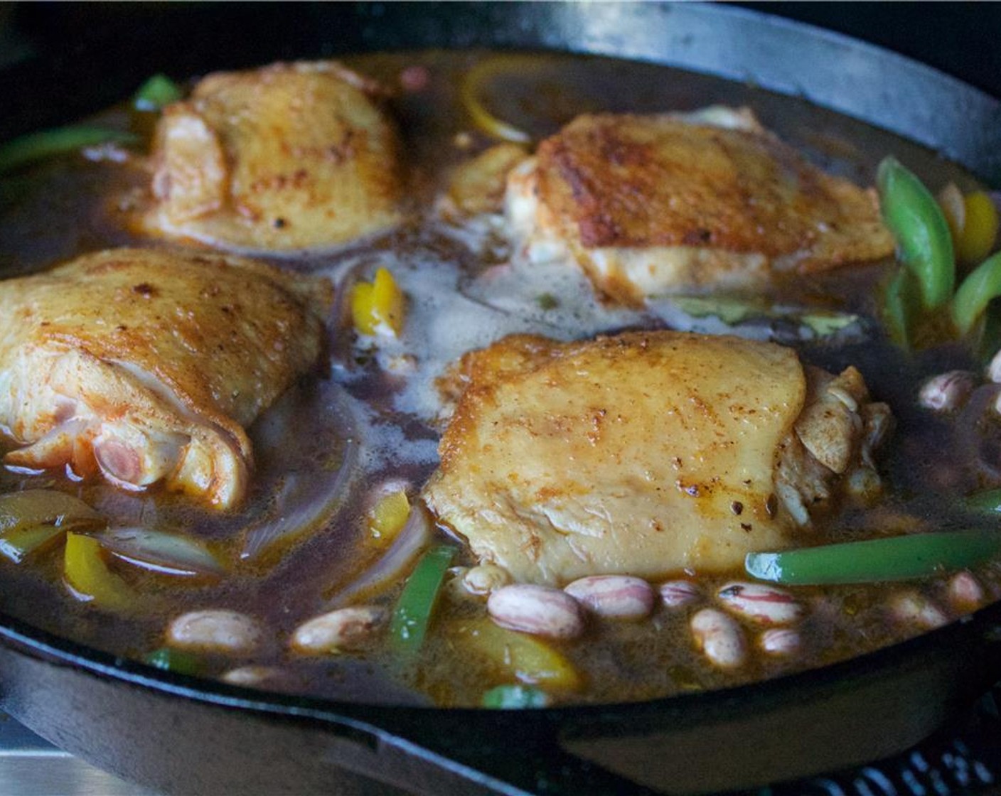step 10 Add in the drained beans and Chicken Stock (4 cups) and combine. Add the Chicken Thighs back to the pan. Bring the stock to a boil, and reduce to a simmer for an hour until the beans and chicken are cooked through. Remove the bay leaf.