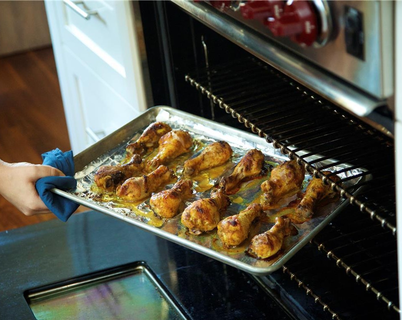 step 7 Dip each drumstick into the yogurt mixture, one at a time, completely coating each leg. Place chicken evenly spaced on foil lined sheet pan with slits facing up. Roast for forty minutes until the chicken is golden brown and cooked through.