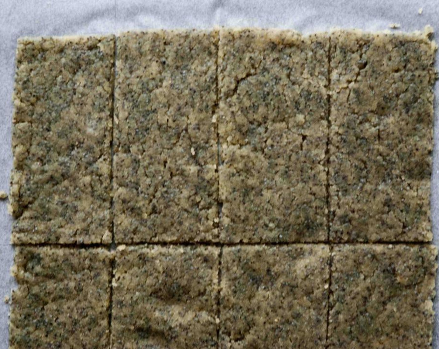 step 4 Transfer mixture to a parchment-lined baking sheet. Cover with parchment; roll out dough to an 8x12-inch rectangle. Uncover, and cut into 12 2x4-inch crackers using a paring knife.