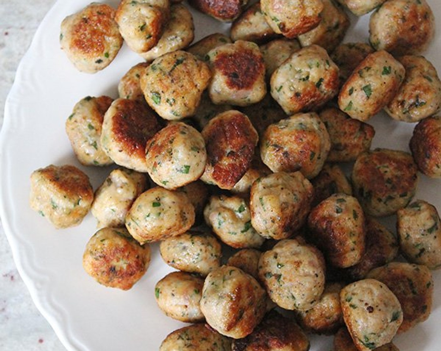 step 5 Flip and cook for an additional 2 minutes, then set aside on a paper-towel-lined plate and repeat with the remaining meatballs.