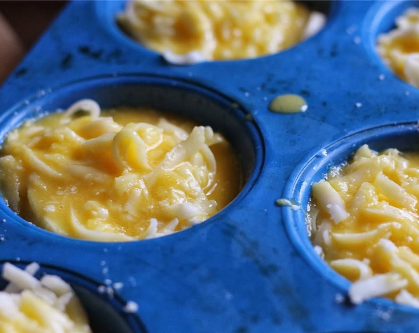 step 6 Melt Butter (1/4 cup). Whisk together Eggs (3) and melted butter. Pour egg mixture evenly into each muffin cup.  Push the eggplant and cheese down a little to mix the egg mixture evenly through the layers.