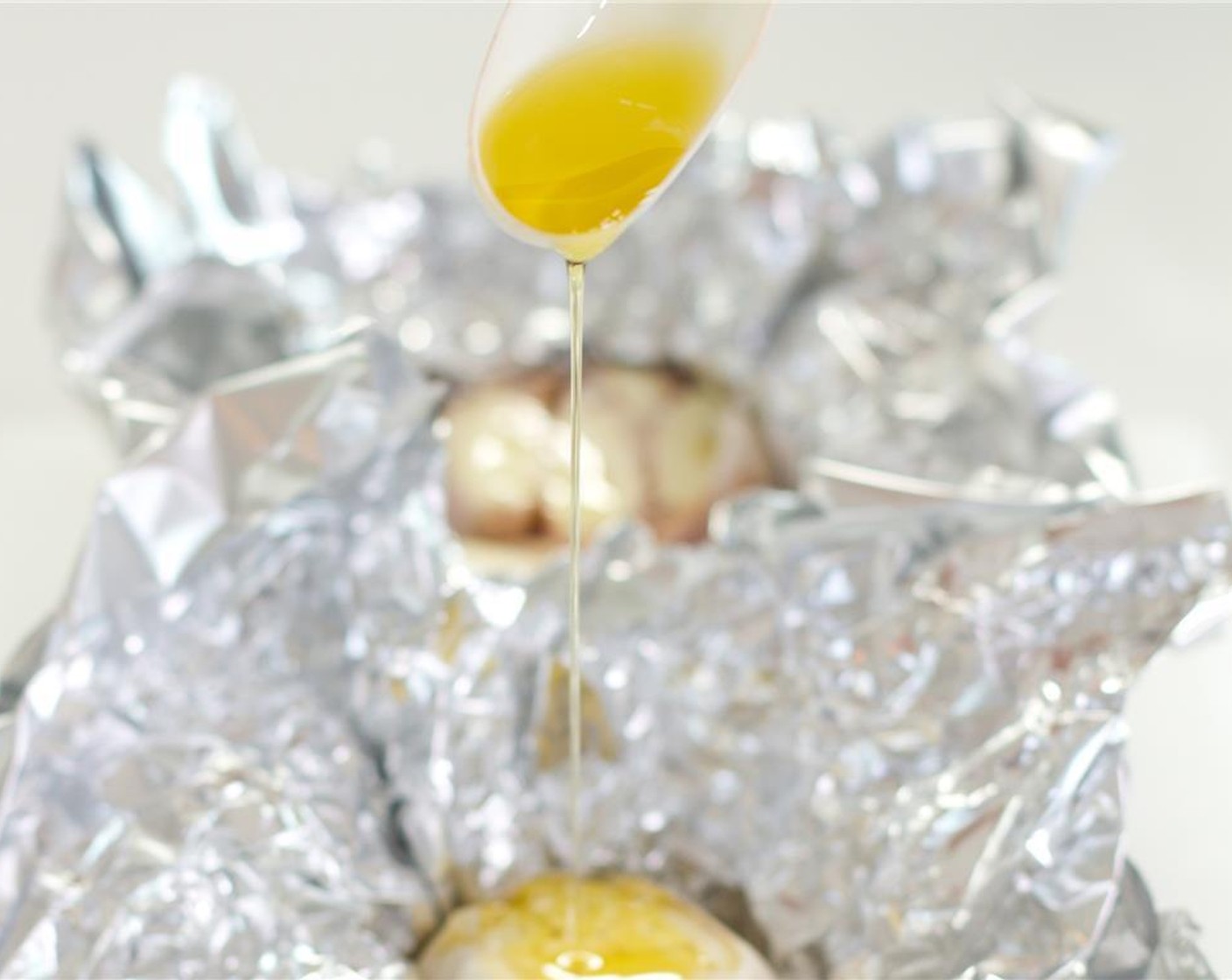 step 4 Drizzle the garlic with the Extra-Virgin Olive Oil (as needed) and dust with Salt (to taste) and Ground Black Pepper (to taste). Pinch the foil together to form a sealed pouch.