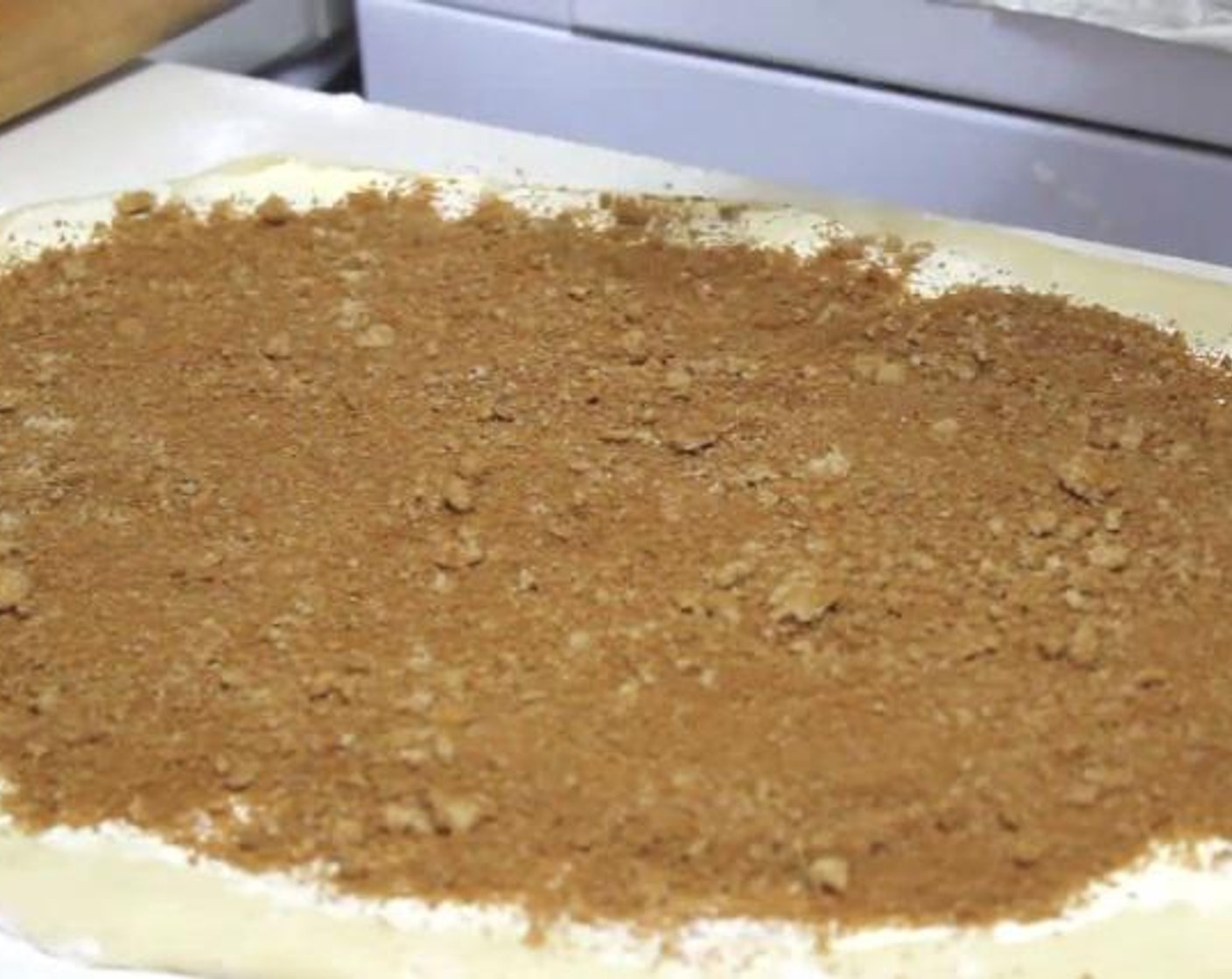 step 7 Then, take the Butter (1/3 cup) and spread it evenly over the surface of the dough. Sprinkle with a mixture of the Ground Cinnamon (2 Tbsp), and Brown Sugar (1 cup).