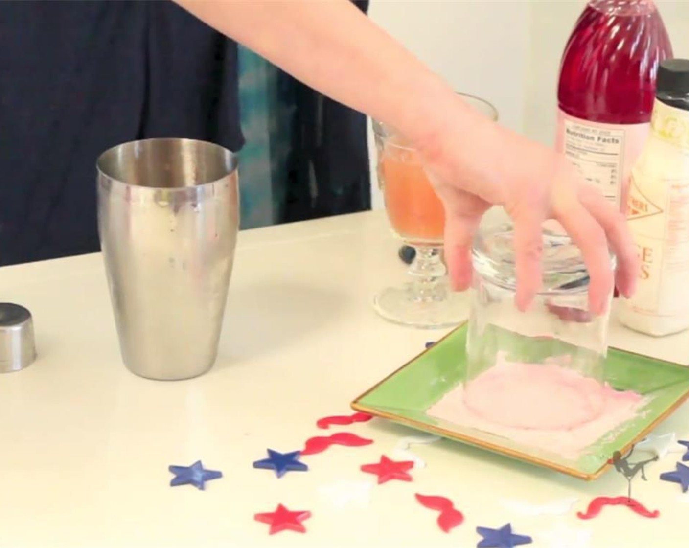 step 4 Pour Red Pixy Stix (to taste) onto a plate, wet the rim of a cocktail glass, and dip rim in the red pixy stix. Fill glass with ice.