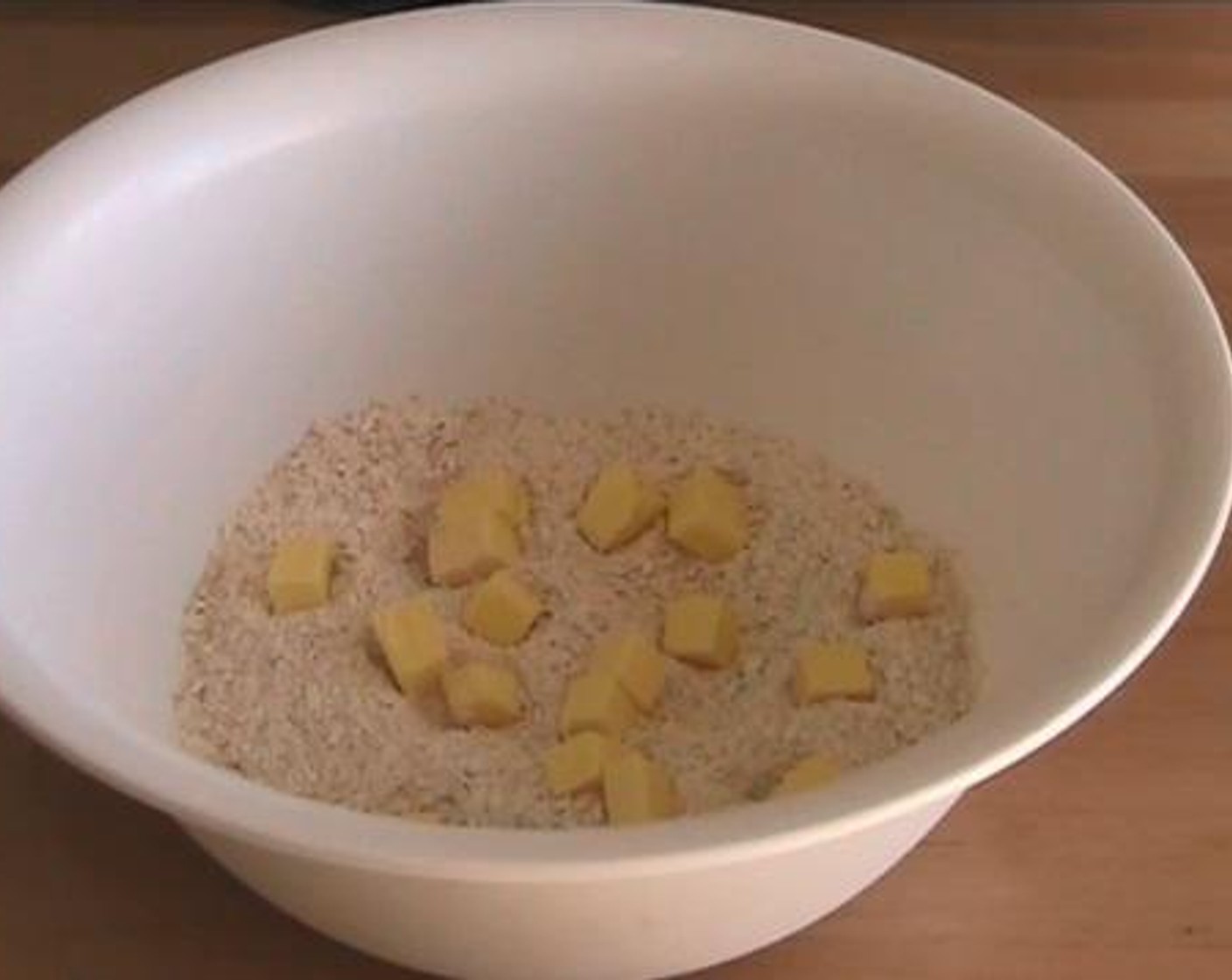 step 3 Into a large mixing bowl, add in the All-Purpose Flour (1 cup), crumbled Old Fashioned Rolled Oats (3 cups), and Butter (4 Tbsp). Rub the mixture together. Then, add in the Brown Sugar (1/3 cup) and milk mixture and combine everything together.