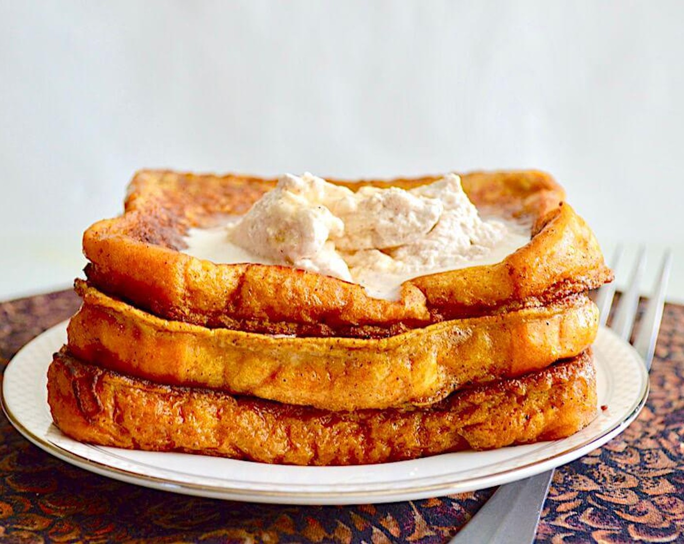 step 5 Serve the cooked French toast with a generous dollop of the whipped cream on top and a drizzle of Maple Syrup (to taste). Enjoy!