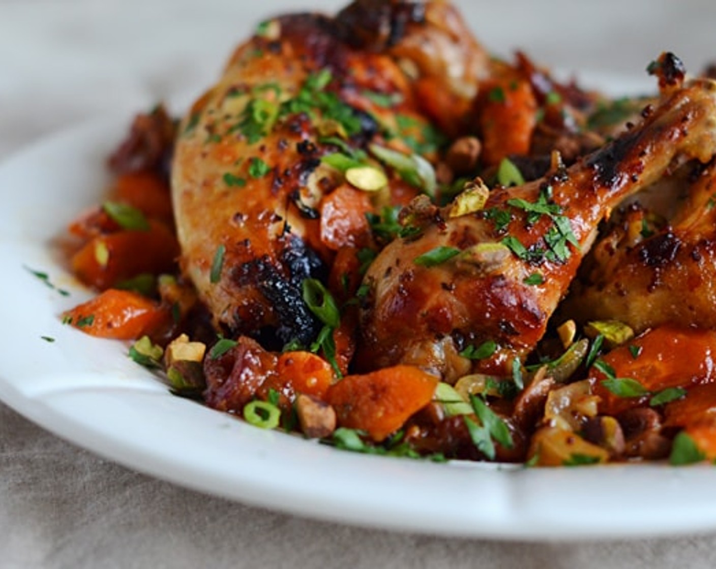 step 8 Transfer the chicken, carrots, onions and dates onto a platter, along with the sauce in the pan. Sprinkle with Italian Flat-Leaf Parsley (2 Tbsp), Scallion (1 bunch), and Salted Pistachios (1/4 cup) over the top and serve.