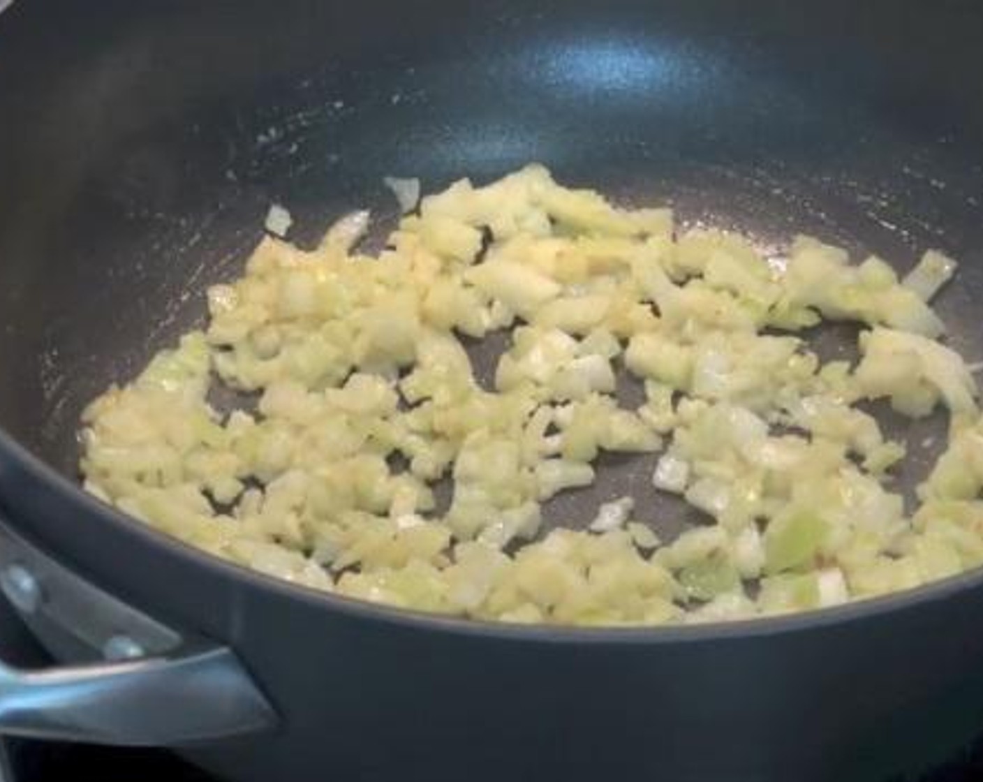 step 3 Take the browned chicken fillets from the pan and set aside. In the same pan, cook the Yellow Onion (1), and Garlic (2 cloves) for about 2 minutes.