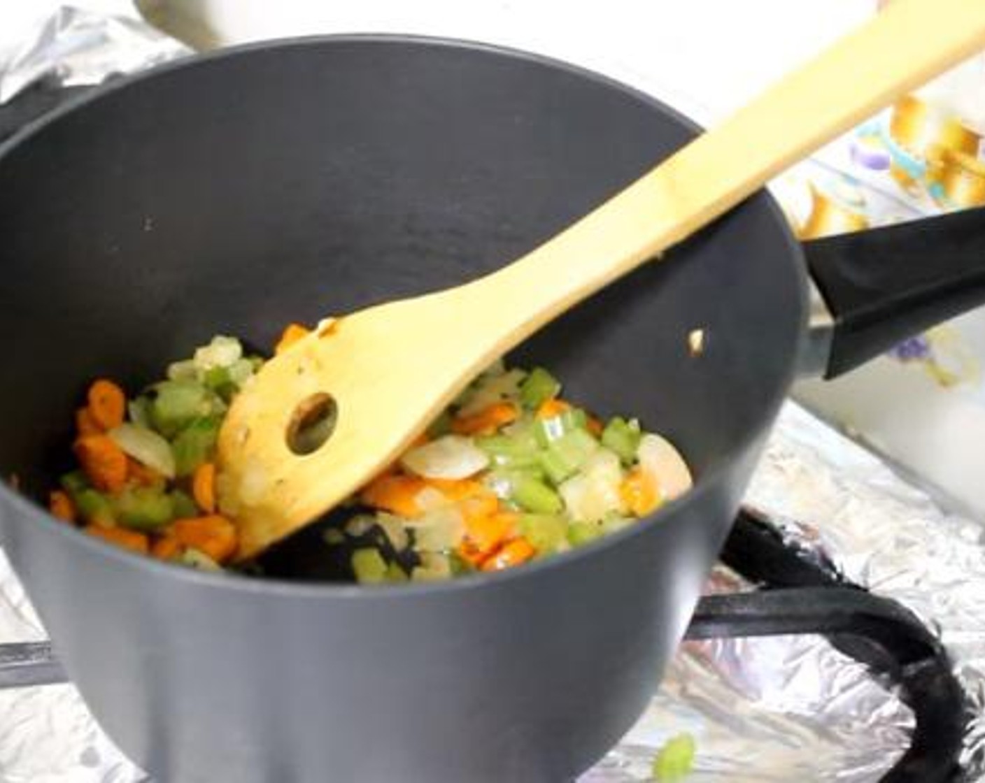 step 3 Into a cooking pan, add the Extra-Virgin Olive Oil (2 Tbsp), Butter (4 Tbsp) Onion (1 cup), Carrot (2/3 cup), Celery (2/3 cup), Salt (1/2 tsp), and Freshly Ground Black Pepper (to taste). Give the mixture a gentle stir and cook for about 5 minutes.