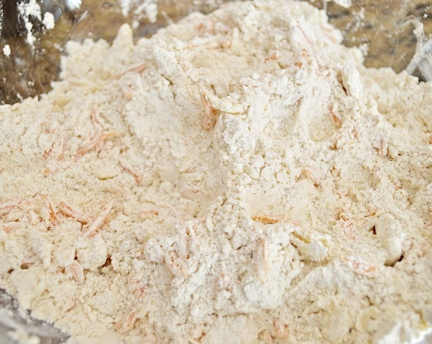 step 3 In a bowl, whish the All-Purpose Flour (375 g), Baking Powder (2 Tbsp), Dark Brown Sugar (2 Tbsp), Salt (1 tsp), and Ground Cumin (1 tsp) together. Then use a pastry cutter to cut in the Butter (120 mL) and Shredded Cheddar Cheese (115 g) until the mixture is pebbly and the butter is all coated in flour.