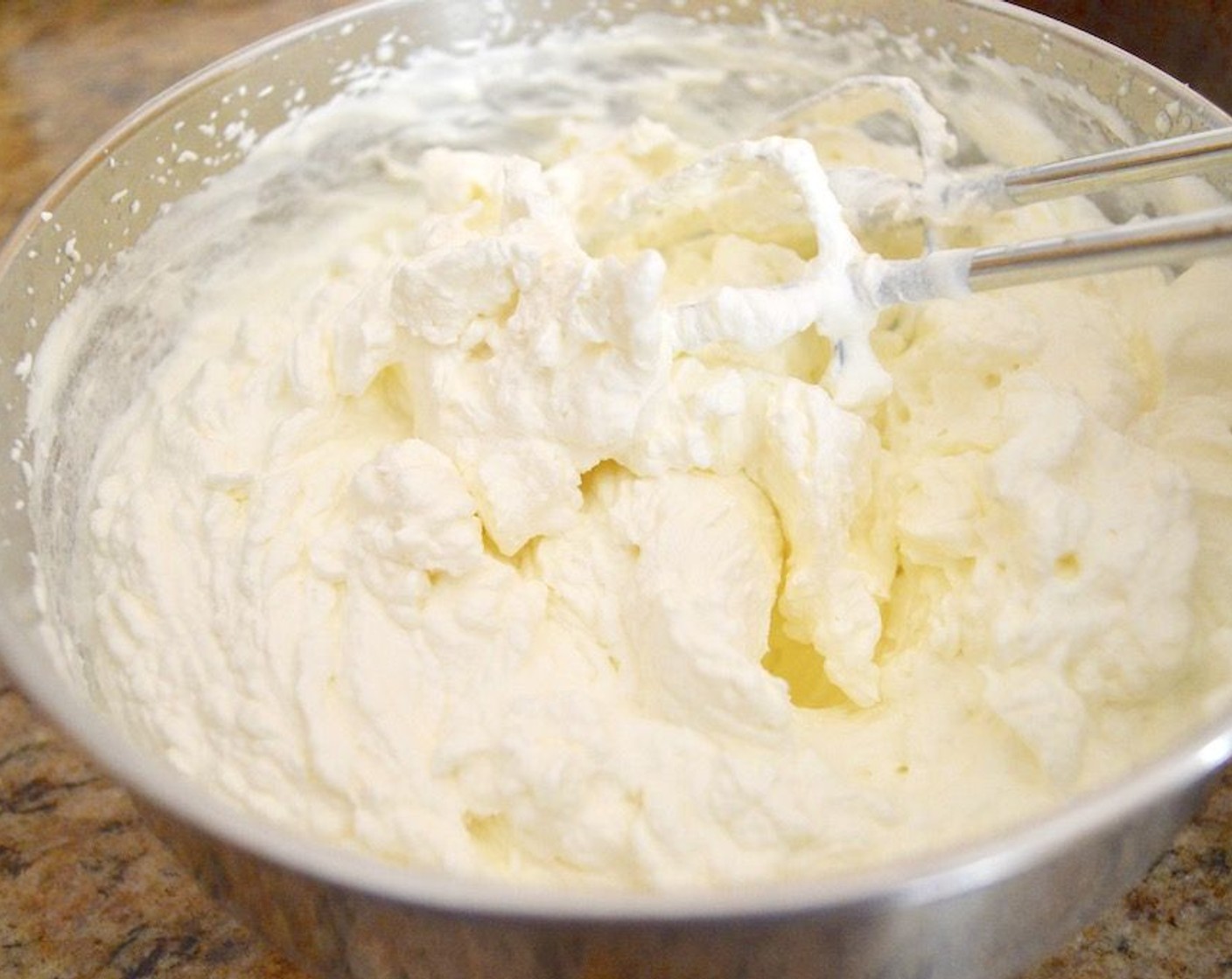 step 10 Make the whipped cream. Combine the Heavy Cream (16 fl oz), Caster Sugar (2 Tbsp), and 1 teaspoons of zest from the Lemon (1) in a mixing bowl and use a hand mixer to whip it up into stiff peaks. It should be airy but not runny at all. Then it is time to assemble this baby!