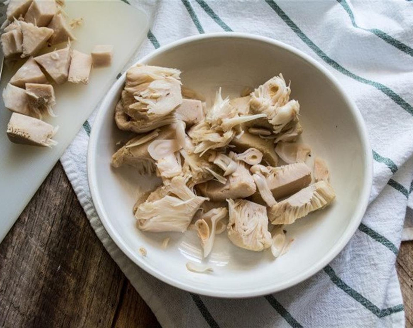 step 1 Rinse, drain and pat the Young Green Jackfruit in Water (1 can) dry, then cut off the center core of each piece and discard.