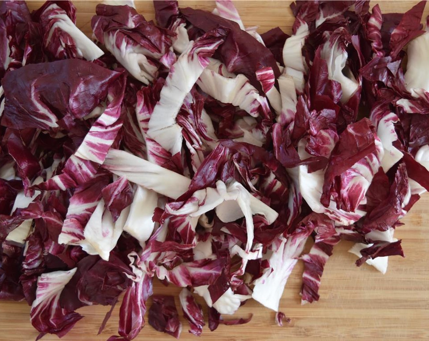 step 4 Tear the Radicchio (1 head) in pieces, then thinly slice the Fennel Bulb (1/2). Shave the pieces of Manchego Cheese (1 cup) and chop the Kalamata Olives (to taste).