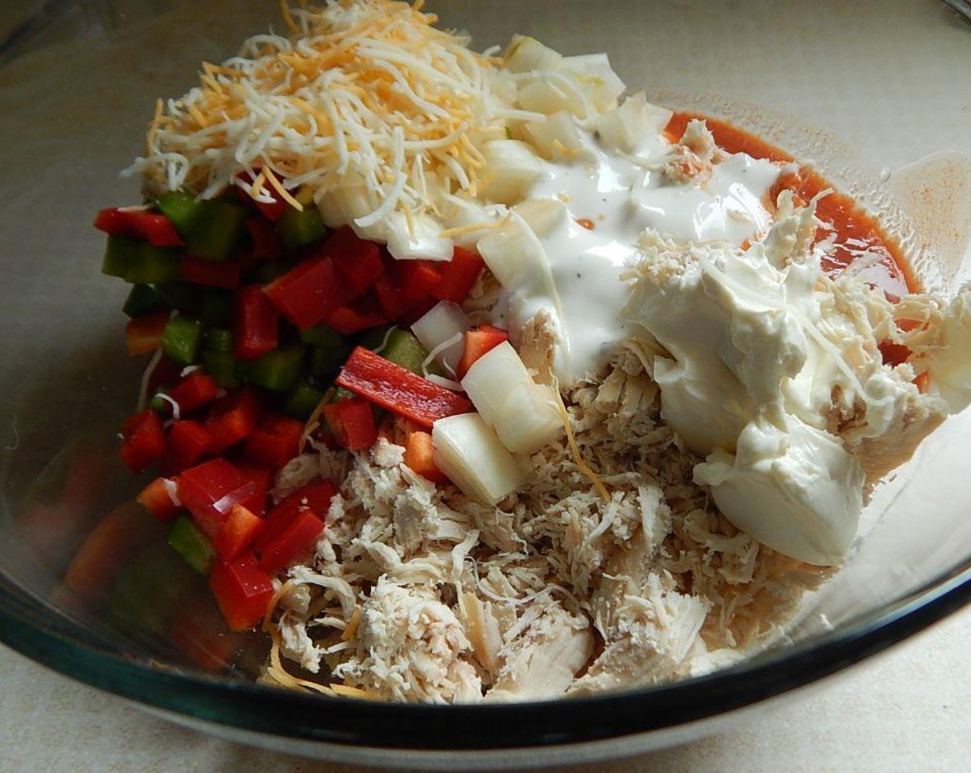 step 4 In a large bowl, mix together Chicken (3 cups), Bell Pepper (1 cup), Onion (3/4 cup), Frank's® RedHot® Sauce (1/4 cup), Fat-Free Ranch Dressing (3 Tbsp), Fat-Free Cream Cheese (1/4 cup), and Light Shredded Cheese Blend (1/3 cup).