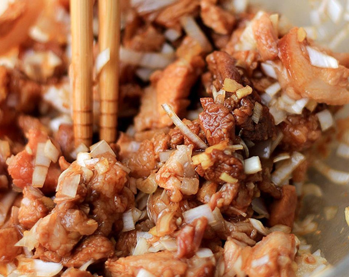 step 1 To make the filling, cut the Char Siu (9 oz) into small cubes and then mix in the Fresh Ginger (1) that have been soaked in Water (1 Tbsp) and finely chopped Shallots (2 Tbsp).