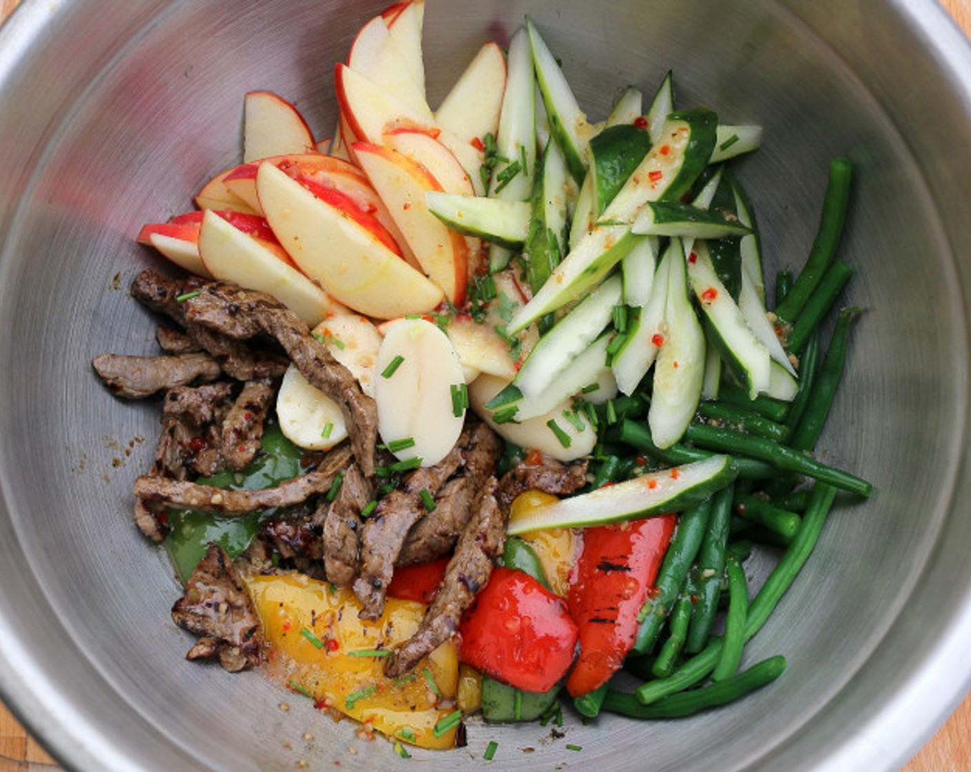 step 7 Mix the steak, apple, peppers, beans, and Cucumbers (2) with the Raspberry Vinaigrette (1 cup). Save a small amount of dressing to drizzle over the top.
