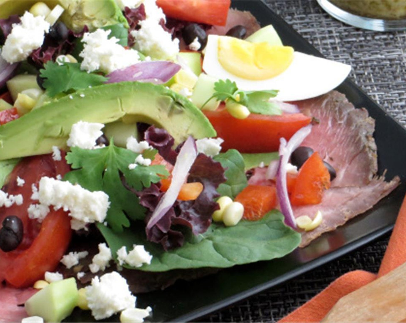 step 3 Spoon several tablespoons of lime vinaigrette over the salad. Toss with salad tongs until mixture is lightly coated. Stack dressed salad atop the cooked steak. Arrange Eggs (2), Avocado (1) on top. Sprinkle with Fresh Cilantro (1/2 cup)