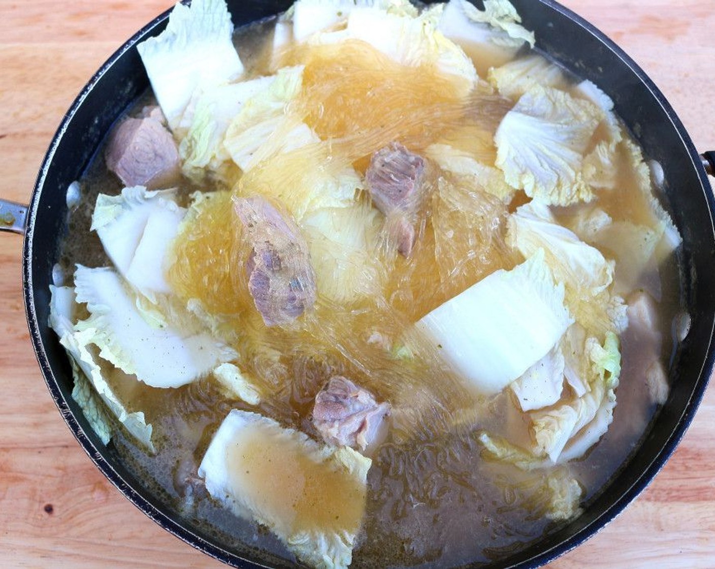 step 8 Add Napa Cabbage (3 cups) and Toasted Sesame Oil (1 Tbsp). Stir. Simmer for another minute or until the rice sticks have the proper texture, then check and adjust seasoning.