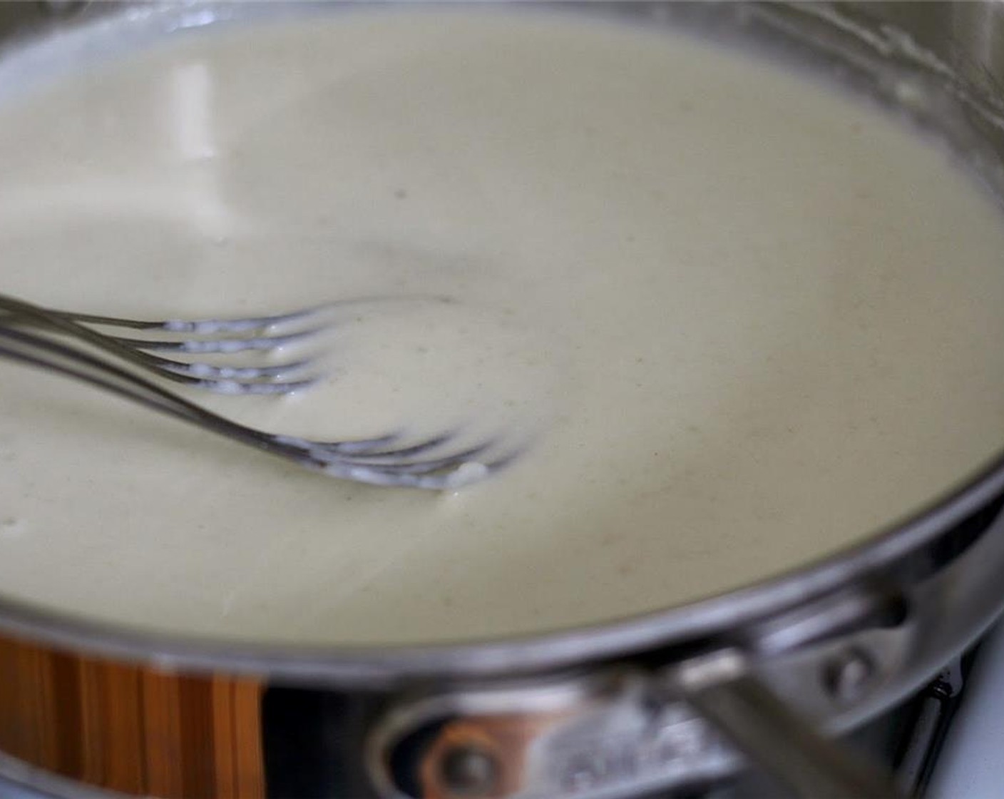 step 4 Gradually whisk in warm milk. Continue cooking, stirring often, until sauce is simmering and thickened. Let sauce bubble gently until thick, about 5-10 minutes longer, stirring often so it doesn't scorch on the bottom.