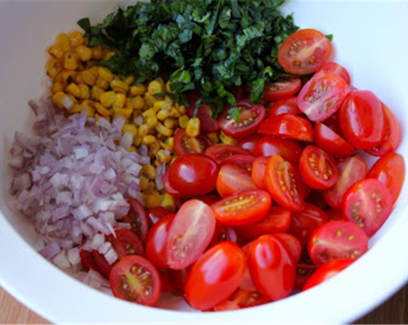 step 3 Slice the Cherry Tomatoes (2 cups) lengthwise and add them to the corn along with the Shallot (1) and Fresh Basil (3/4 cup).