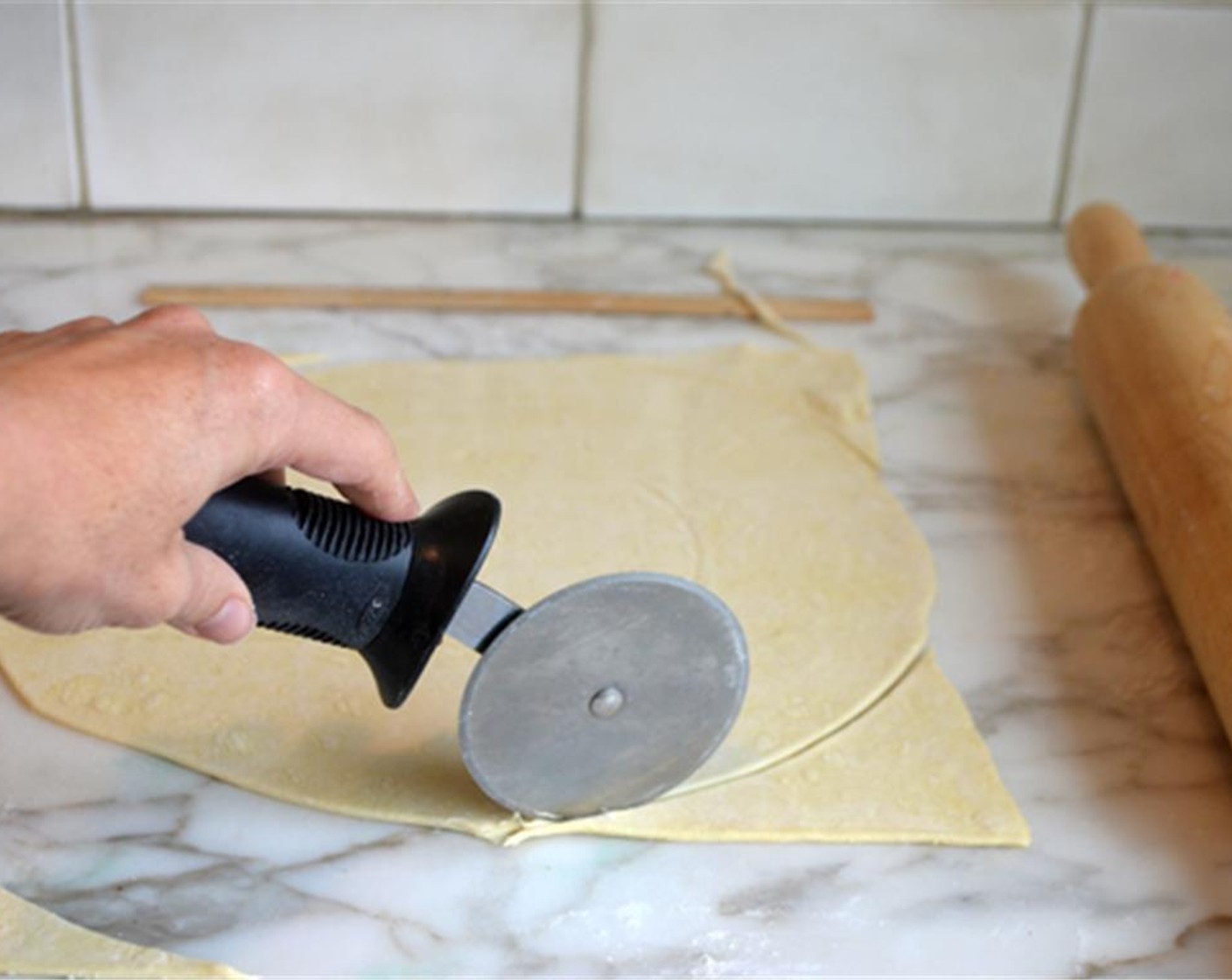 step 2 Roll each Puff Pastry (2 sheets) into a 12-inch square. Trim the corners to make two circles.