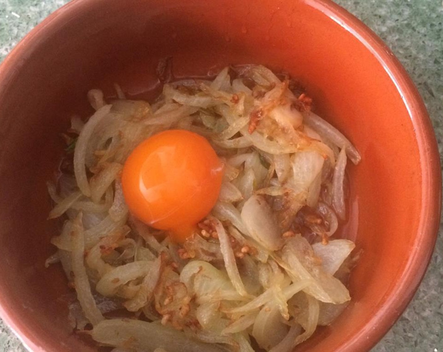 step 3 When the onion and the garlic are done, put them in a earthen bowl. Add the Eggland's Best Classic Egg (1).