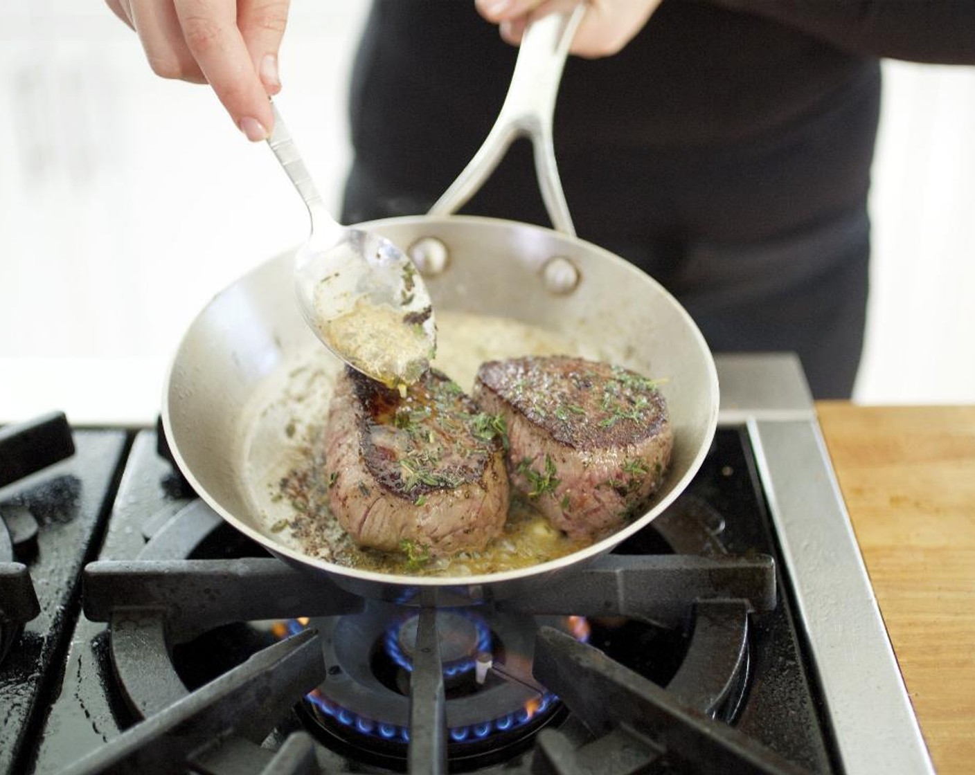 step 10 Turn the steaks over and add the remaining butter and half the thyme leaves. Using a spoon, baste steaks with thyme butter. Cook for 3 to 4 minutes more. Remove steaks from the pan, sprinkle remaining thyme leaves on top, and let the steaks rest.