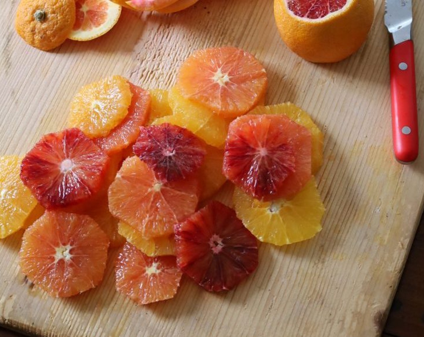 step 4 Using a small serrated knife, peel the Oranges (5) and trim any remaining pith. Slice the oranges crosswise into thin circles about 1/4-inch thick, remove any visible seeds.