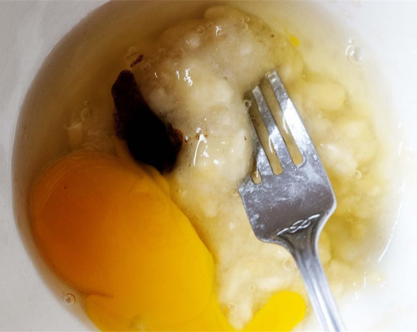 step 2 Mash the bananas with a fork and combine it with the whole Eggs (2) and Vanilla Bean Paste (1/2 tsp).