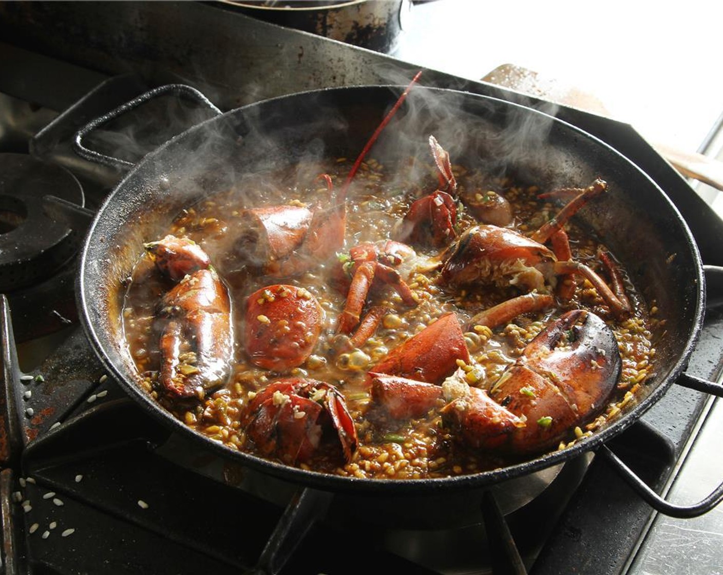 step 20 Transfer the lobster back in the paella. Once almost dry, add some more lobster stock and place in a 350 degrees F (180 degrees C) oven for 5 minutes. Check the cooking point of the rice, it needs to be al dente.