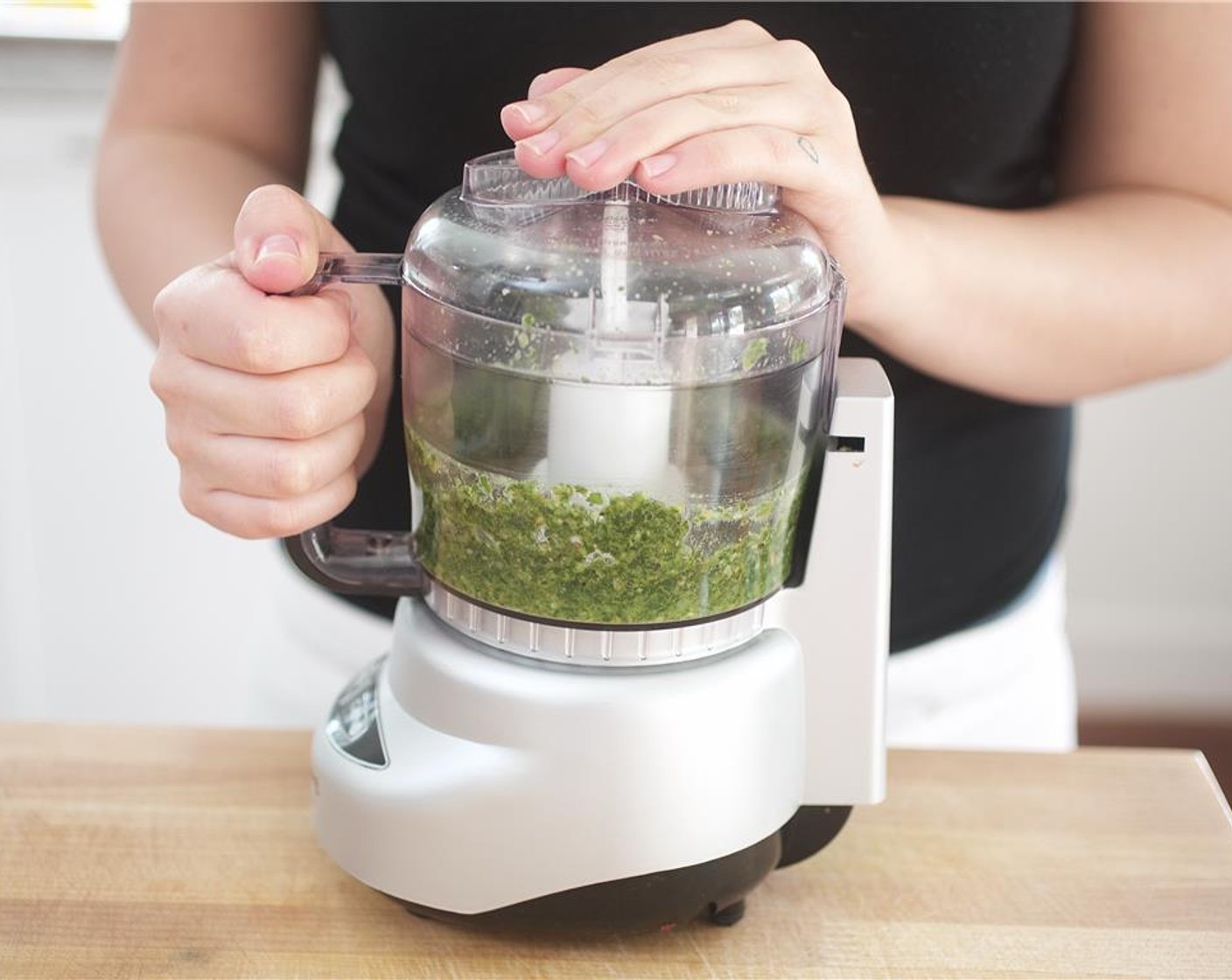 step 7 To create the pesto, pour Olive Oil (1/4 cup), basil leaves, half of the Pine Nuts (2 Tbsp), the last clove of Garlic (1 clove), one tablespoon of Parmesan Cheese (2 Tbsp), Salt (1/2 tsp), and Ground Black Pepper (1/2 tsp) into the bowl of a food processor.