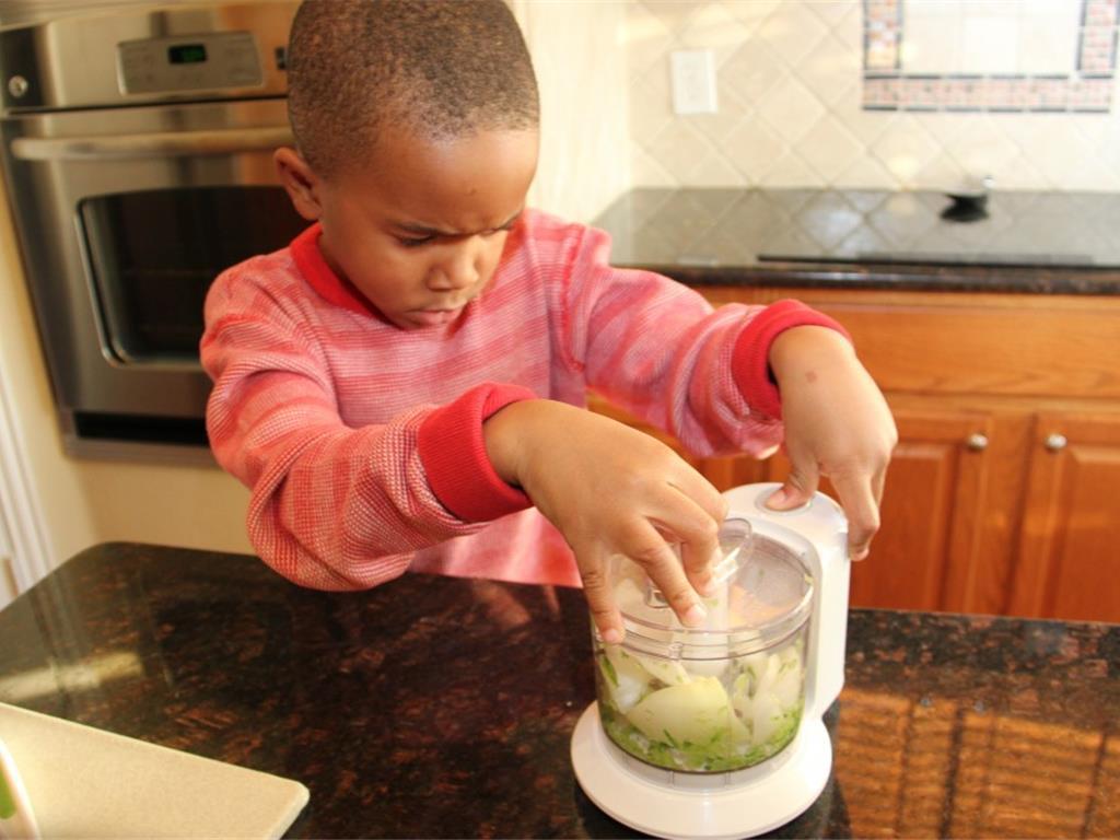 Step 3 of Pizza in a Bowl Recipe: Take the chunks of veggies and place them in an electric chopper.