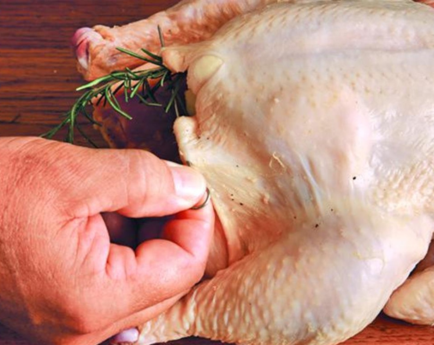 step 3 Work your fingers under the skin of each breast, going as far back as you can. Put two pieces of the cavity fat under the skin on each breast, one in back, toward the wing, the other further forward near the leg.