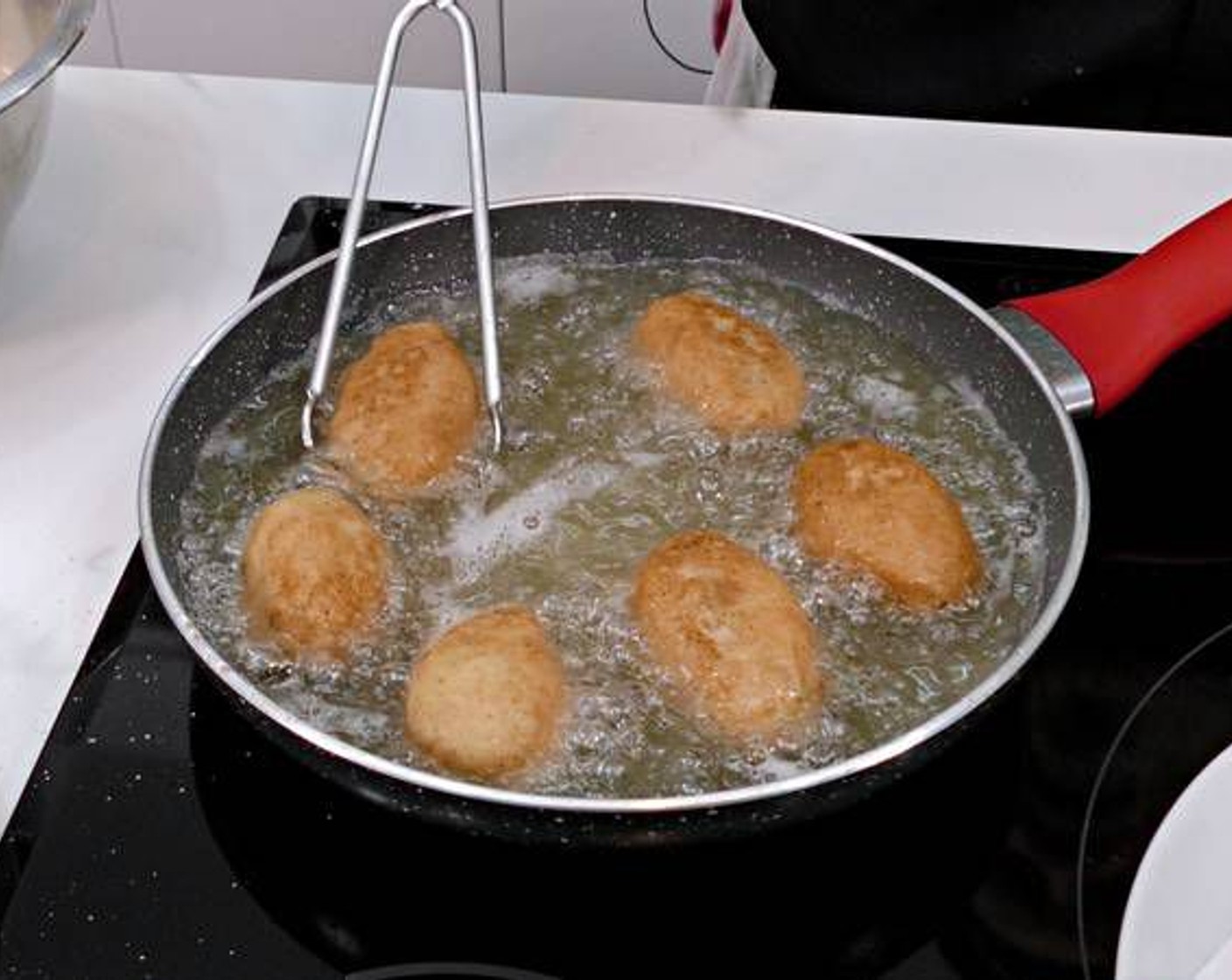 step 9 Heat a generous amount of Frying Oil (as needed) in a pan. Once the oil is really hot we can start adding the croquets. Continue to fry the croquets until golden and crispy.