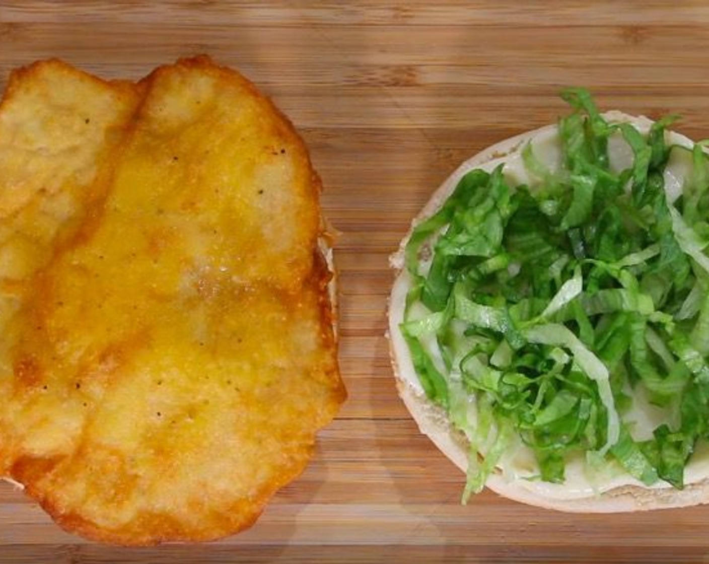 step 11 On the heel bun, place chicken patty. On the crown, spread the special sauce and top with Shredded Iceberg Lettuce (to taste)