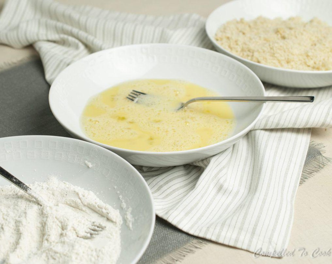 step 4 Using 3 shallow bowls, to the first, add the All-Purpose Flour (1/2 cup), Salt (to taste), and Ground Black Pepper (to taste) and whisk to combine. To the second, add Eggs (2) and Water (1 Tbsp) and whisk to combine. To the third, add the Breadcrumbs (1 1/2 cups).