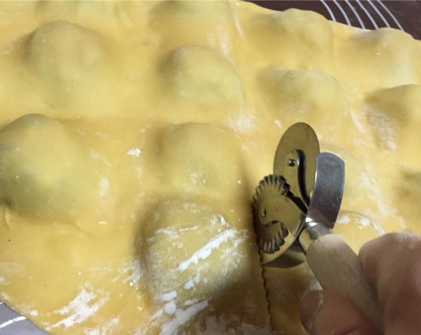 step 4 Gently fold over the other half of the dough and seal by hand between the balls of filling. Cut with pasta or ravioli cutter.
