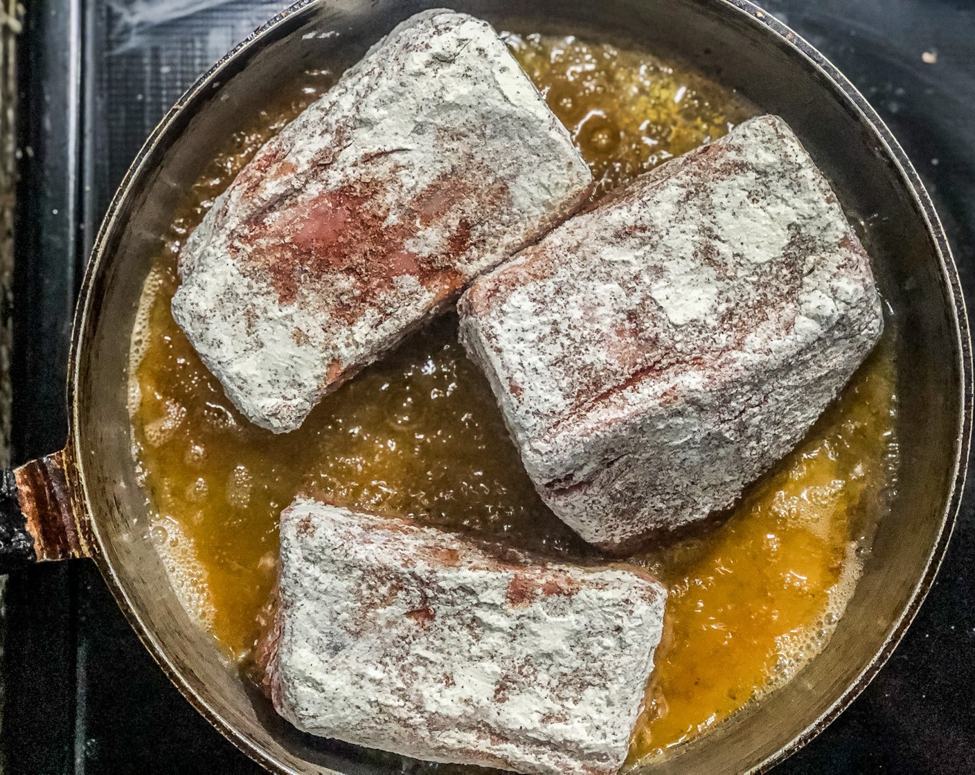 step 4 Dust short ribs in the flour. Once the oil is hot (add a pinch of flour if it sizzles slowly it’s hot) cook them in batches for 1 minute on each side.