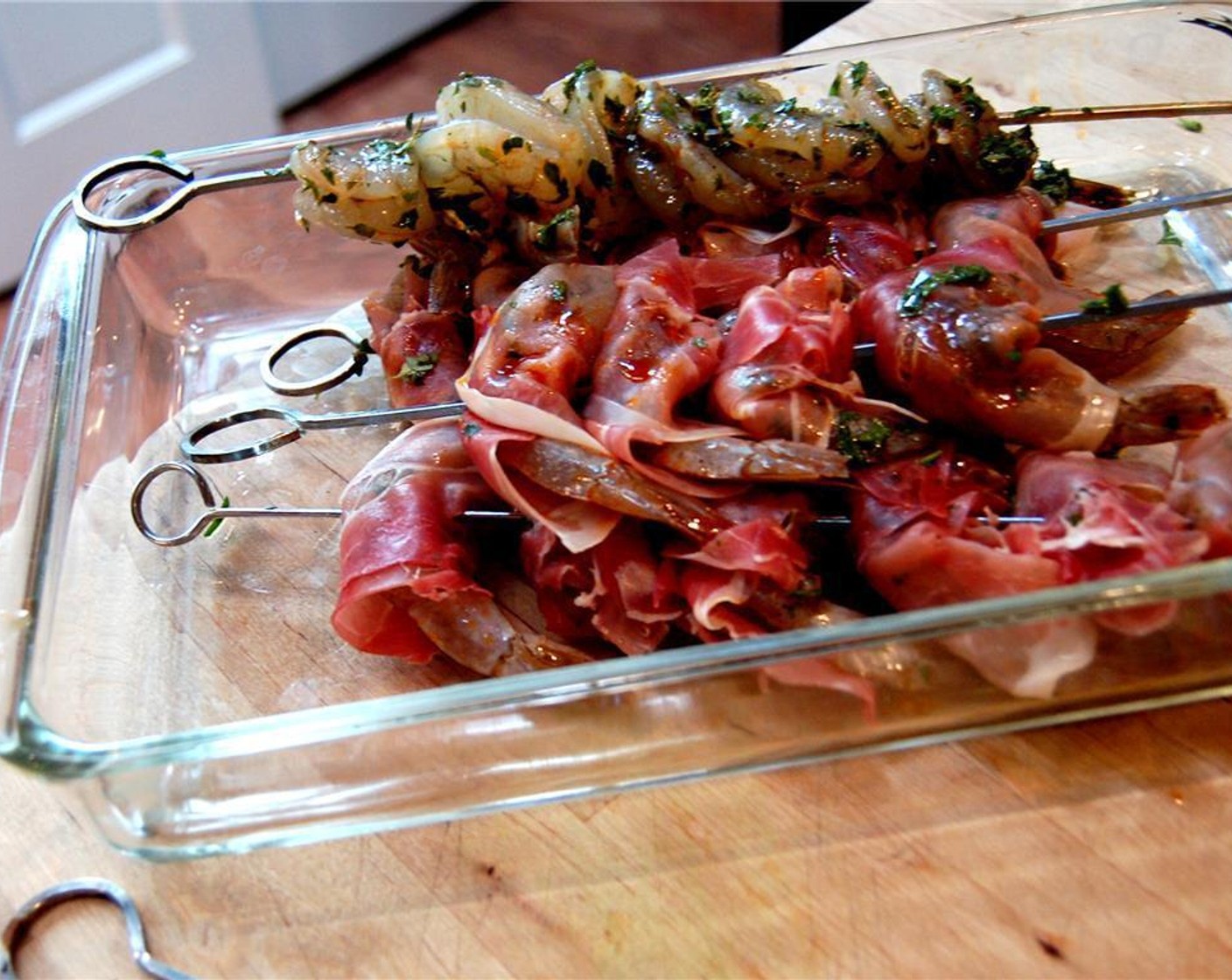 step 3 Remove shrimp from marinade and wrap each piece of shrimp with a piece of Prosciutto (5 oz). Lightly Salt (to taste). Use soaked bamboo skewers (or metal).