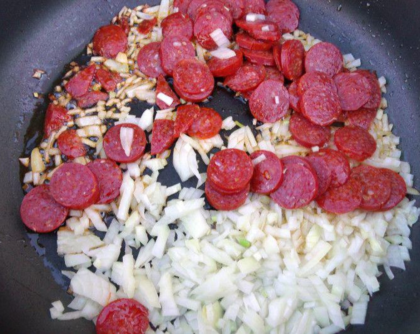 step 5 Saute Onion (3/4 cup) and Linguiça Sausages (4 oz) in Olive Oil (2 Tbsp).