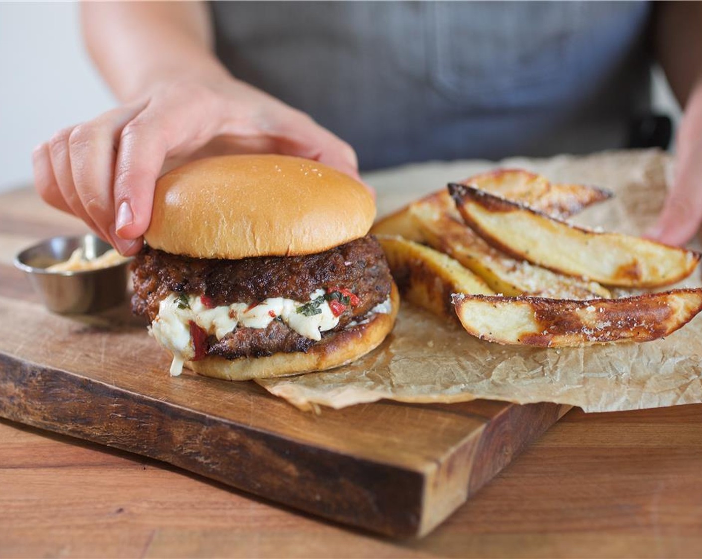 step 15 Spread the garlic mayonnaise on the bottom halves of the buns, and place on two plates. Place burgers, and serve with baked fries and Ketchup (1/4 cup) on the side.