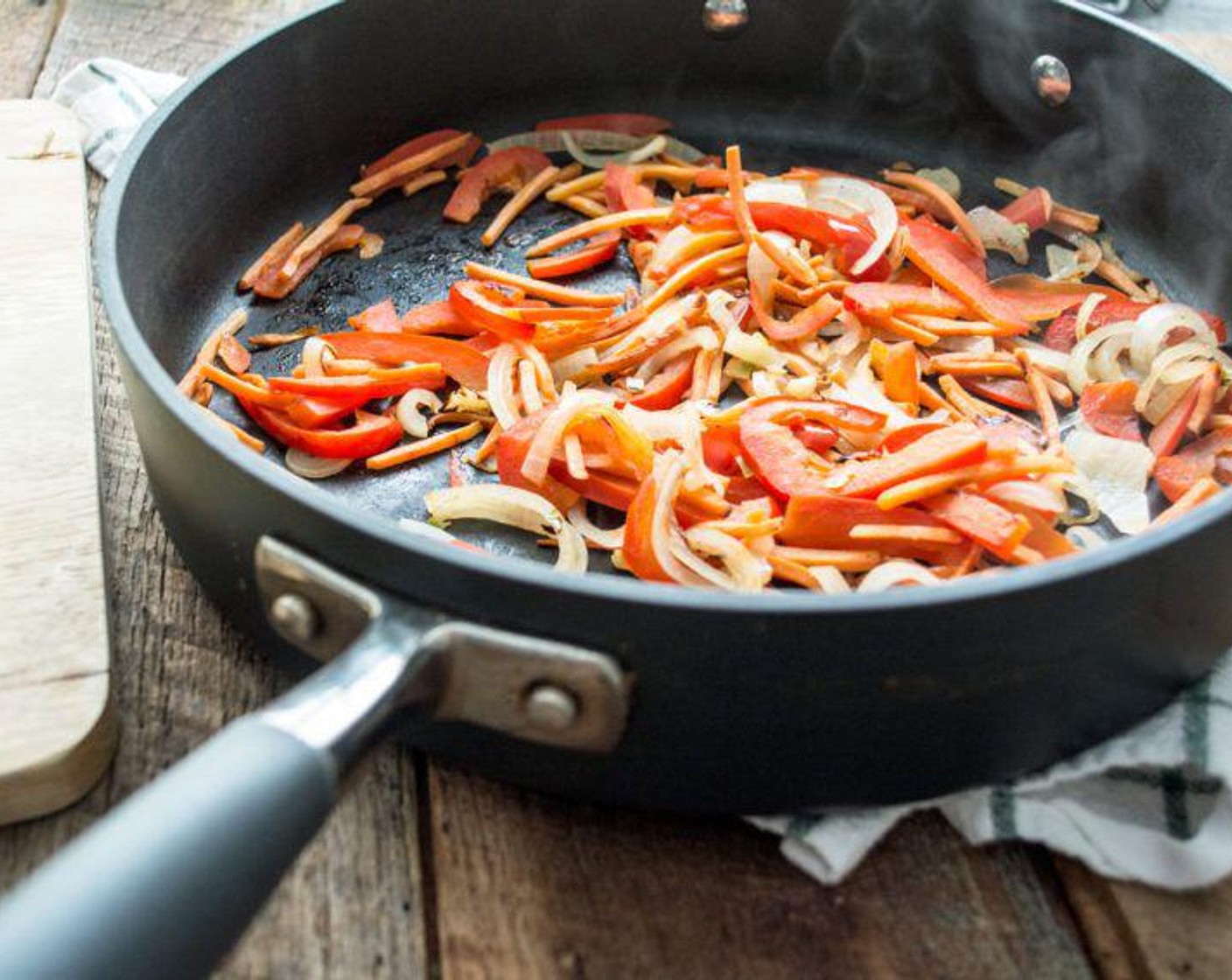 step 3 When the squash has about 10 minutes to go, add Red Bell Pepper (2/3), Sweet Onion (1/2 cup), and Carrot (1/2 cup), to a large sauté pan and cook over medium heat for 3-5 minutes.