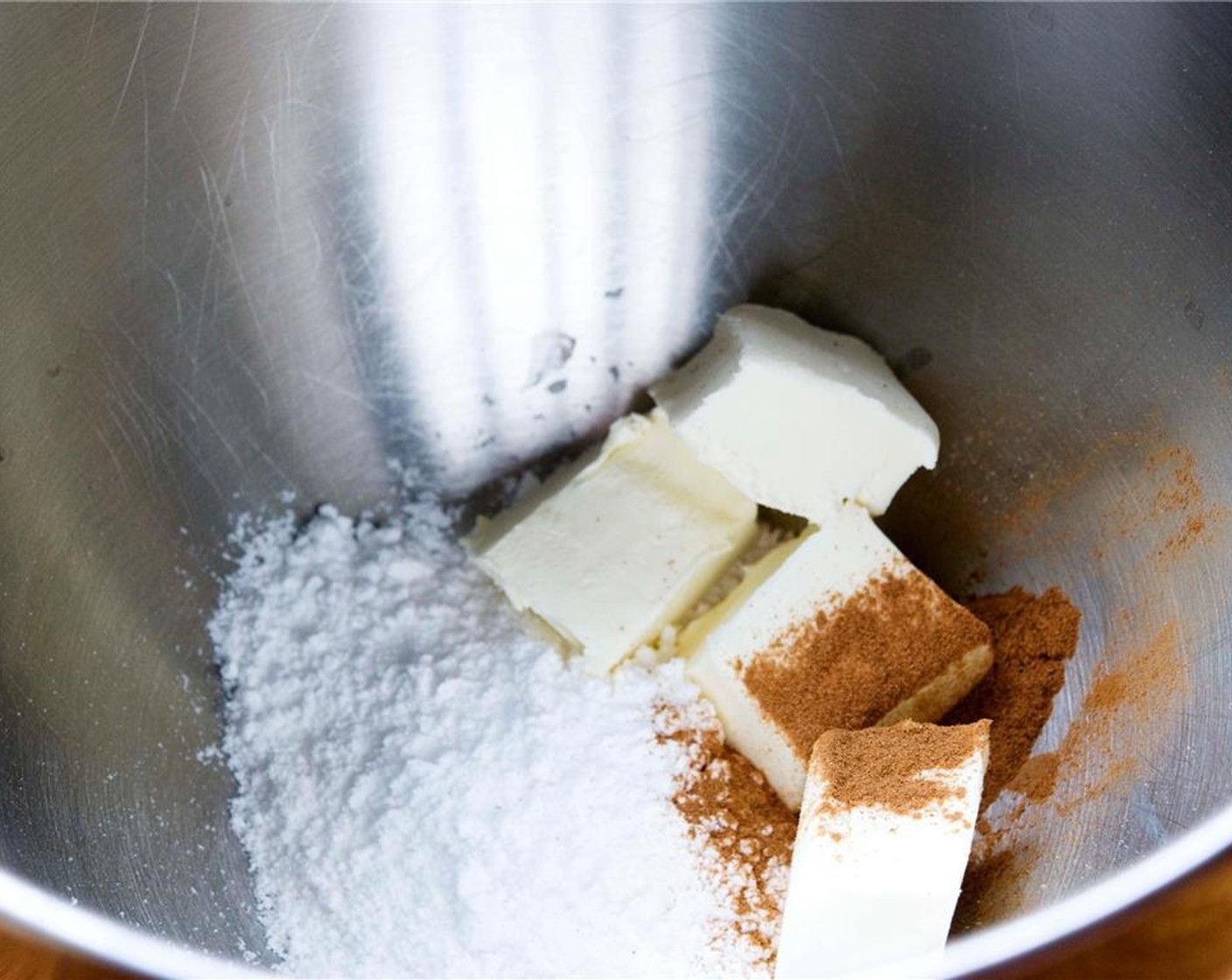 step 6 Prepare the icing by mixing the Powdered Confectioners Sugar (1 cup), Cream Cheese (1/2 cup), and Simply Organic Cinnamon, Ground (1/2 tsp) together with a handheld mixer over medium speed.
